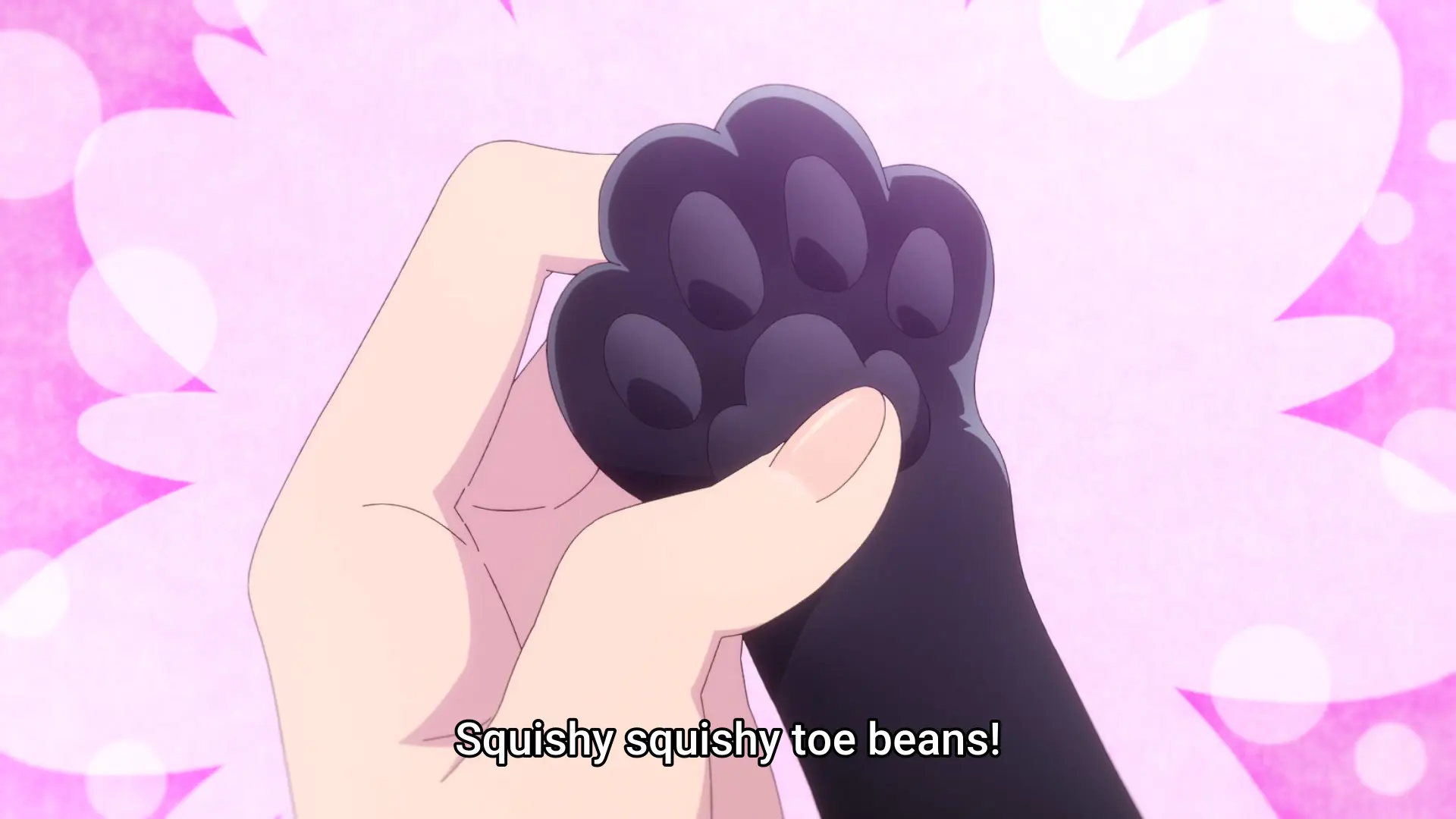 Screenshot from the anime "Rock wa Lady no Tashinami deshite" showing someone holding a black cat's paw. The beans are very prominent. Subtitle: "Squishy squishy toe beans!"