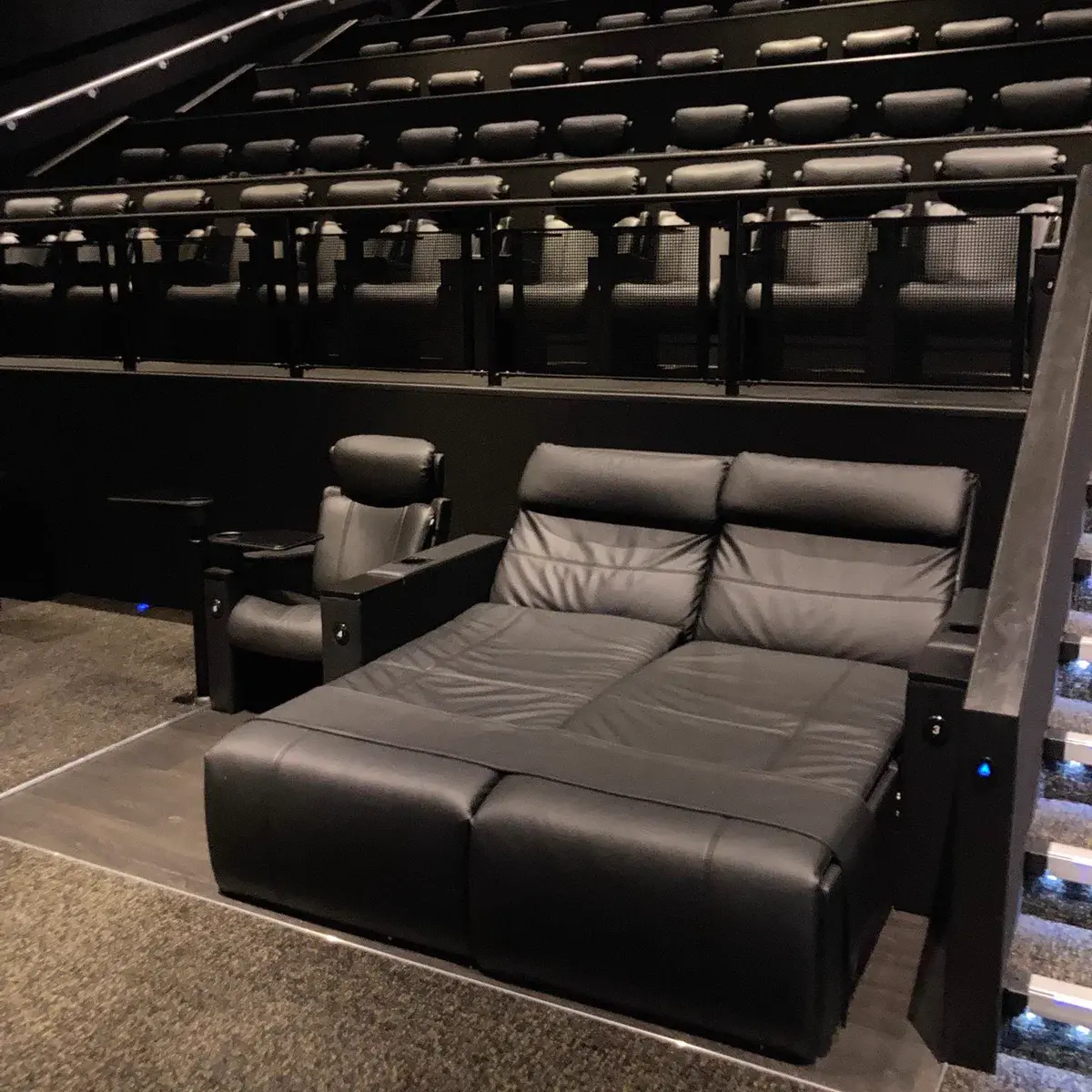 Photo of a an Odeon cinema VIP bed for 2 people. Right next to it is a single small seat.