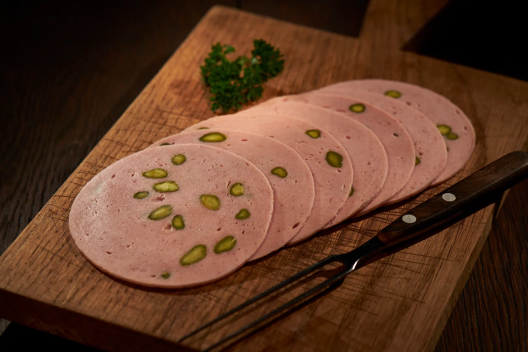 Bologna sausage with pieces of pistachio inside.