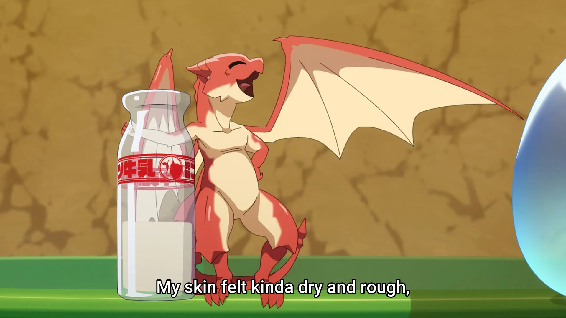Screenshot from the anime "Tondemo Skill de Isekai Hourou Meshi" showing a small red dragon holding a glass bottle as tall as himself. He happily says something while extending one wing.